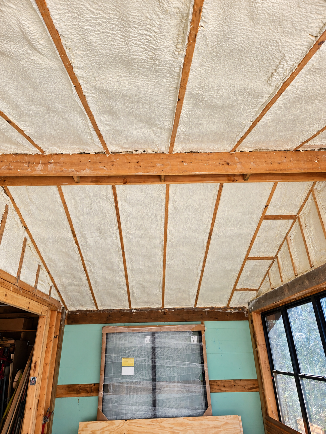 Open framing in a building prepared for spray foam insulation before interior finishes are installed