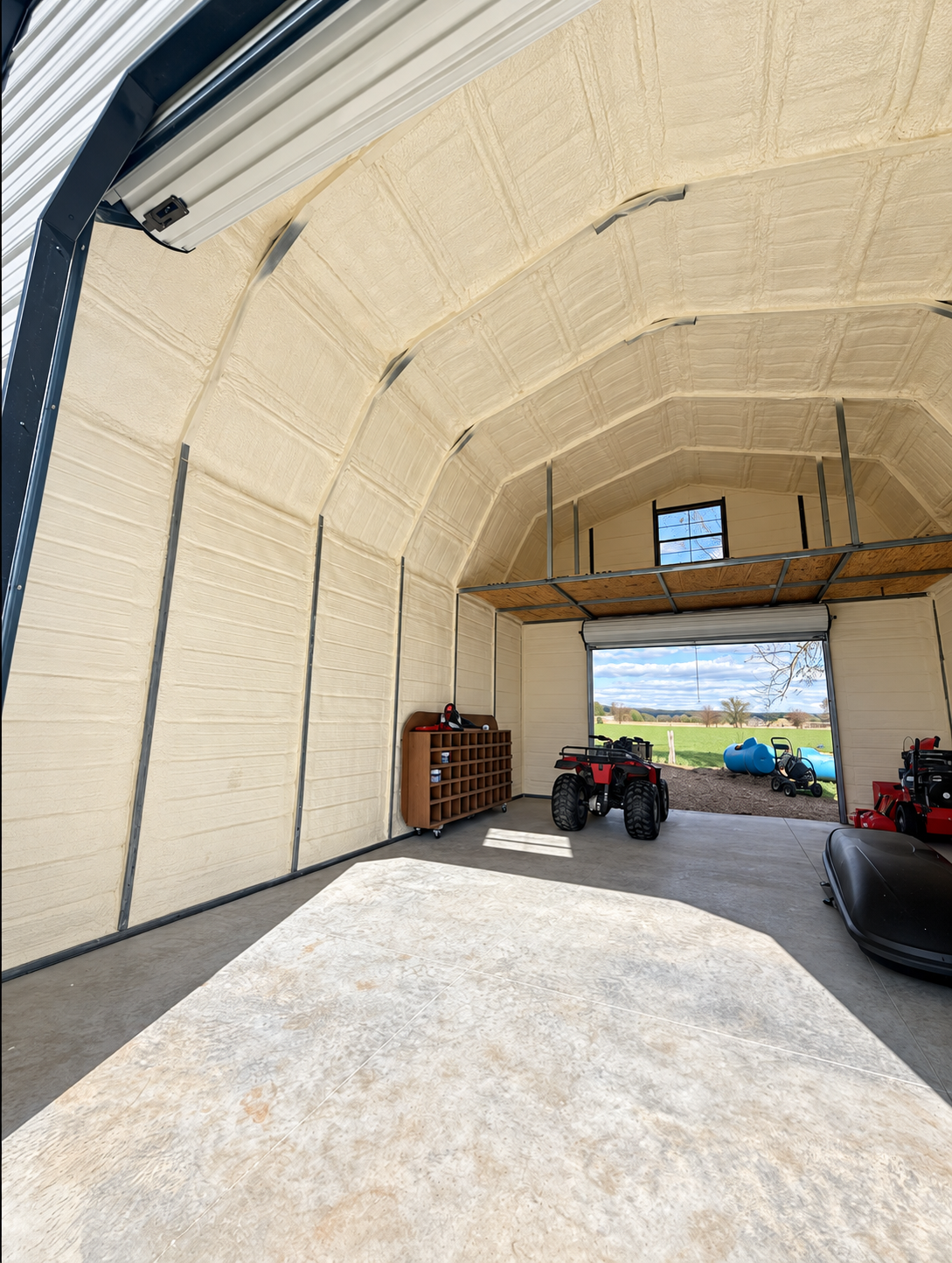 Naturally finished garage with spray foam insulation on the walls and arched ceiling